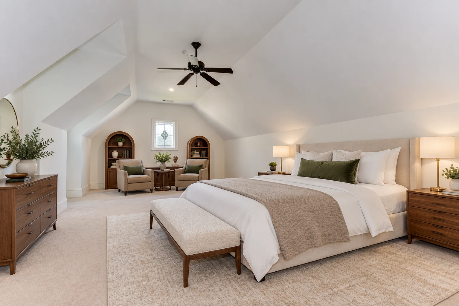 Digitally staged upstairs master bedroom with an upholstered bed, walnut nightstands, and a sitting area beneath the existing sloped ceiling