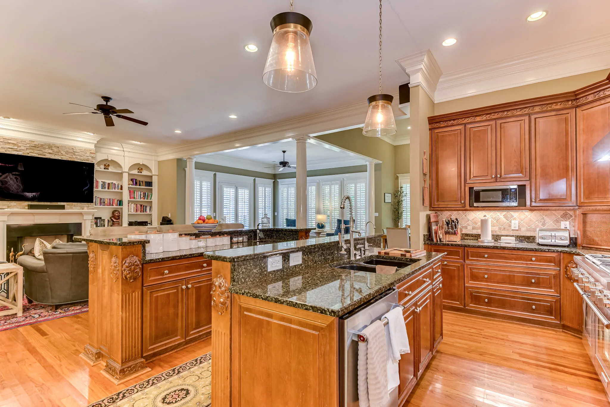 Kitchen with two granite-topped islands and an open view into the living room