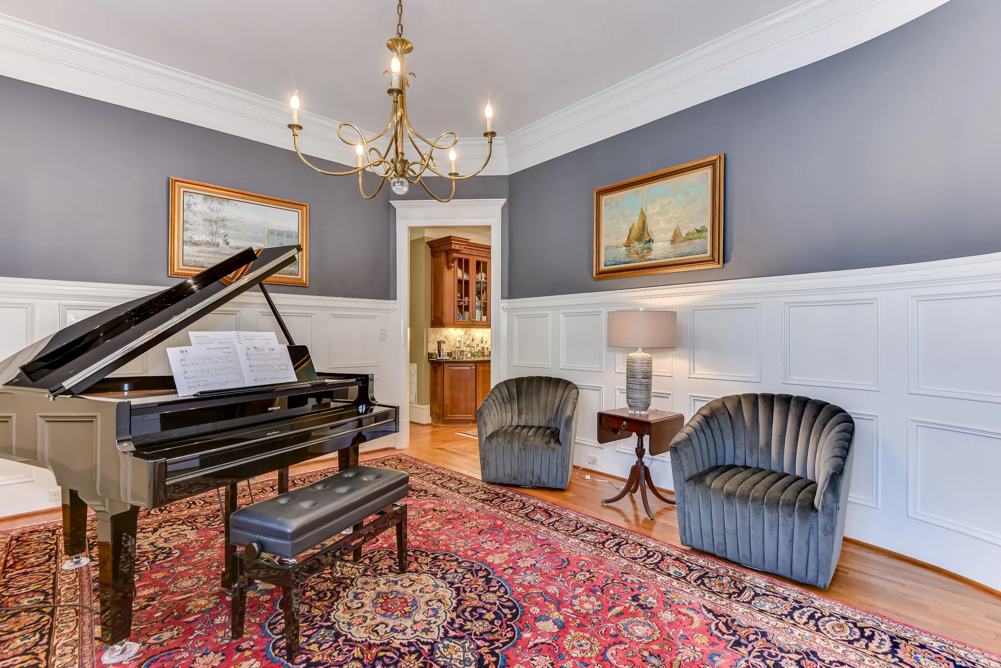 Grand piano and upholstered chairs in the formal piano room
