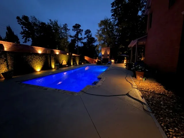 Blue pool lighting and warm landscape lighting at dusk